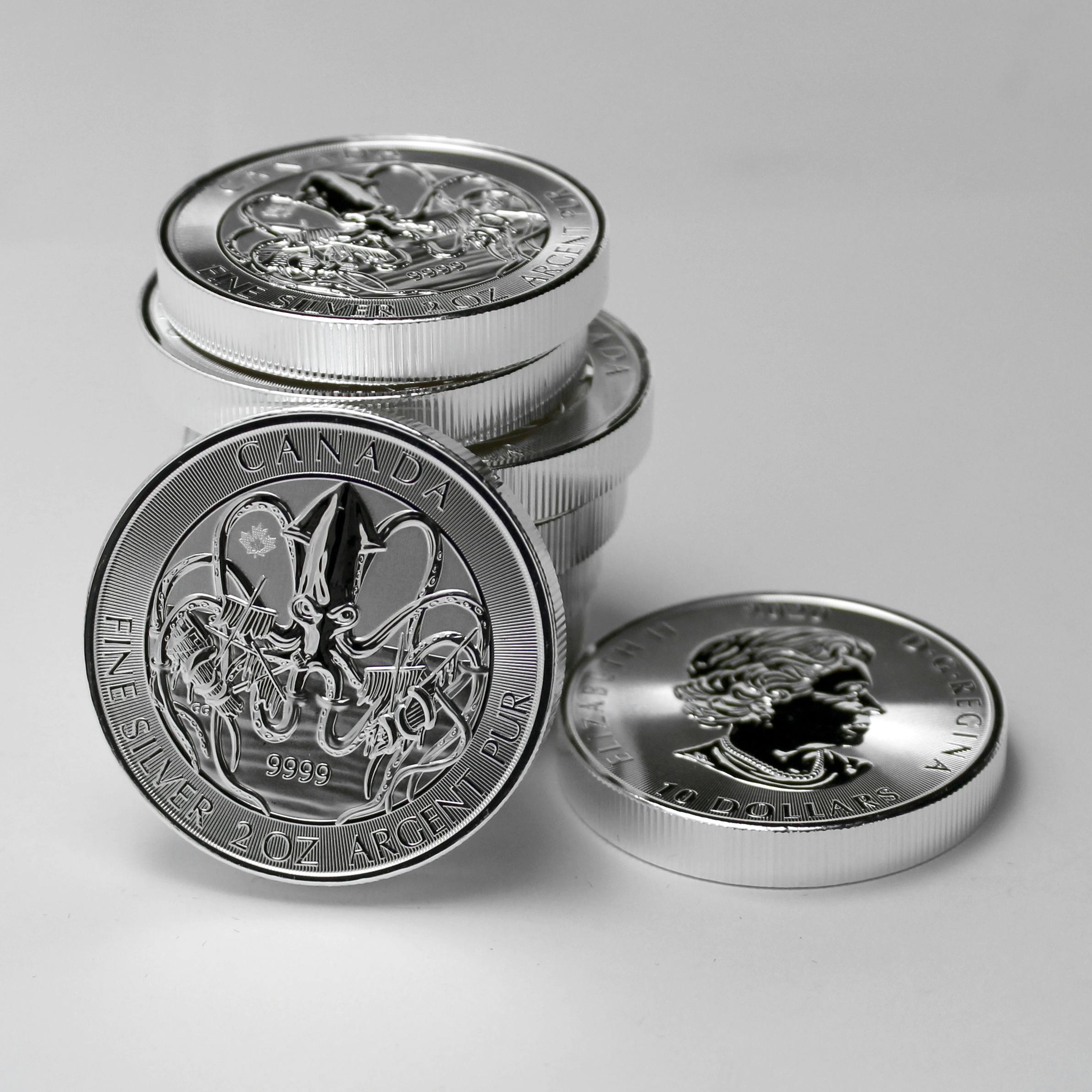 Close-up of Canadian silver coins highlighting intricate designs and monetary value.